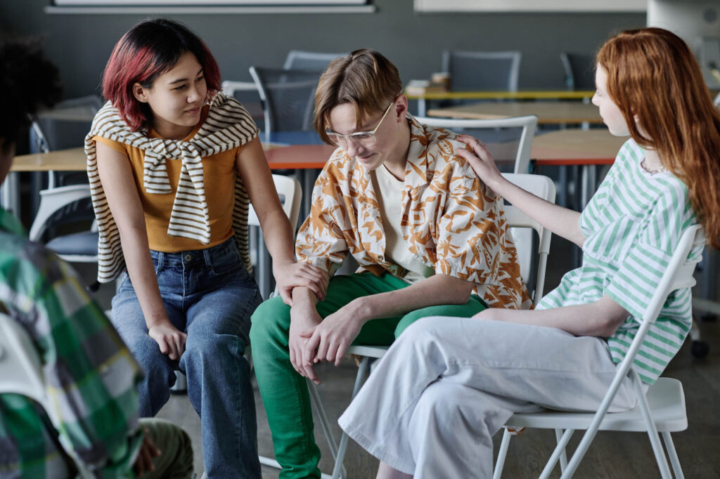 Thrive Mind & Wellness Center | Mental Health Evaluations | Teenagers Supporting Boy At Therapy Session