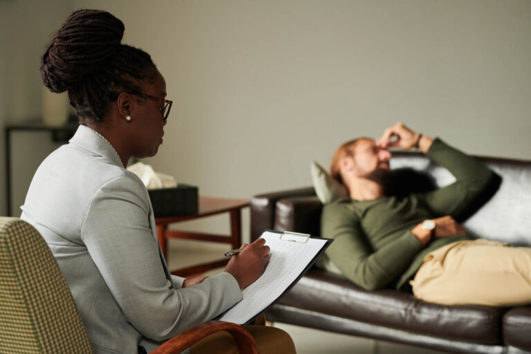 Thrive Mind & Wellness Center | Ongoing Mental Health Care | Psychologist making notes in card during her work with patient