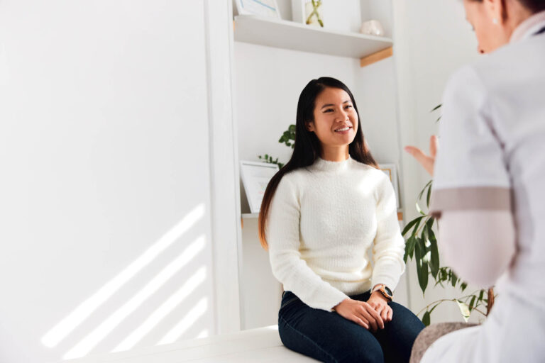 Thrive Mind & Wellness Center | A smiling female patient received good news from a female doctor.